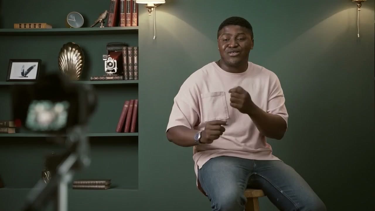 A creator recording a lesson on his phone with a ring light